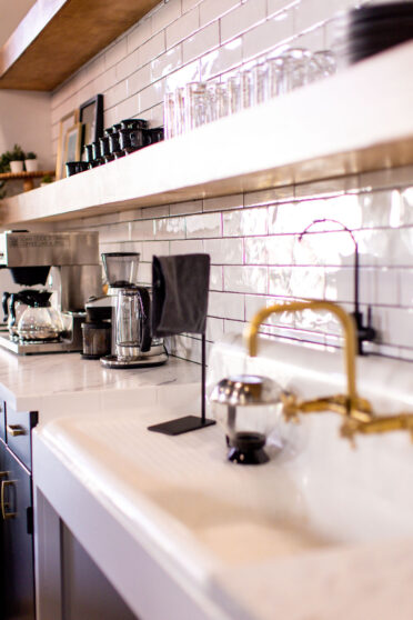 Nest:Space™ coworking kitchen sink, tile backsplash and counter on the main level, designed by Shawna Meyer Design™, Interior Design and Project Management