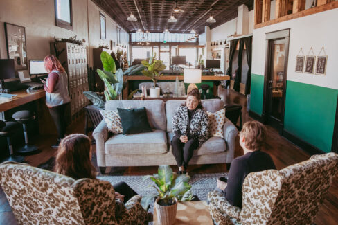 Members meeting in the micro meeting area at Nest:Space™ coworking, on the main level, designed by Shawna Meyer Design™, Interior Design and Project Management