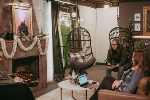 Hanging chairs are perfect comfort seats at Nest:Space™ coworking, in the basement private desk room, designed by Shawna Meyer Design™, Interior Design and Project Management